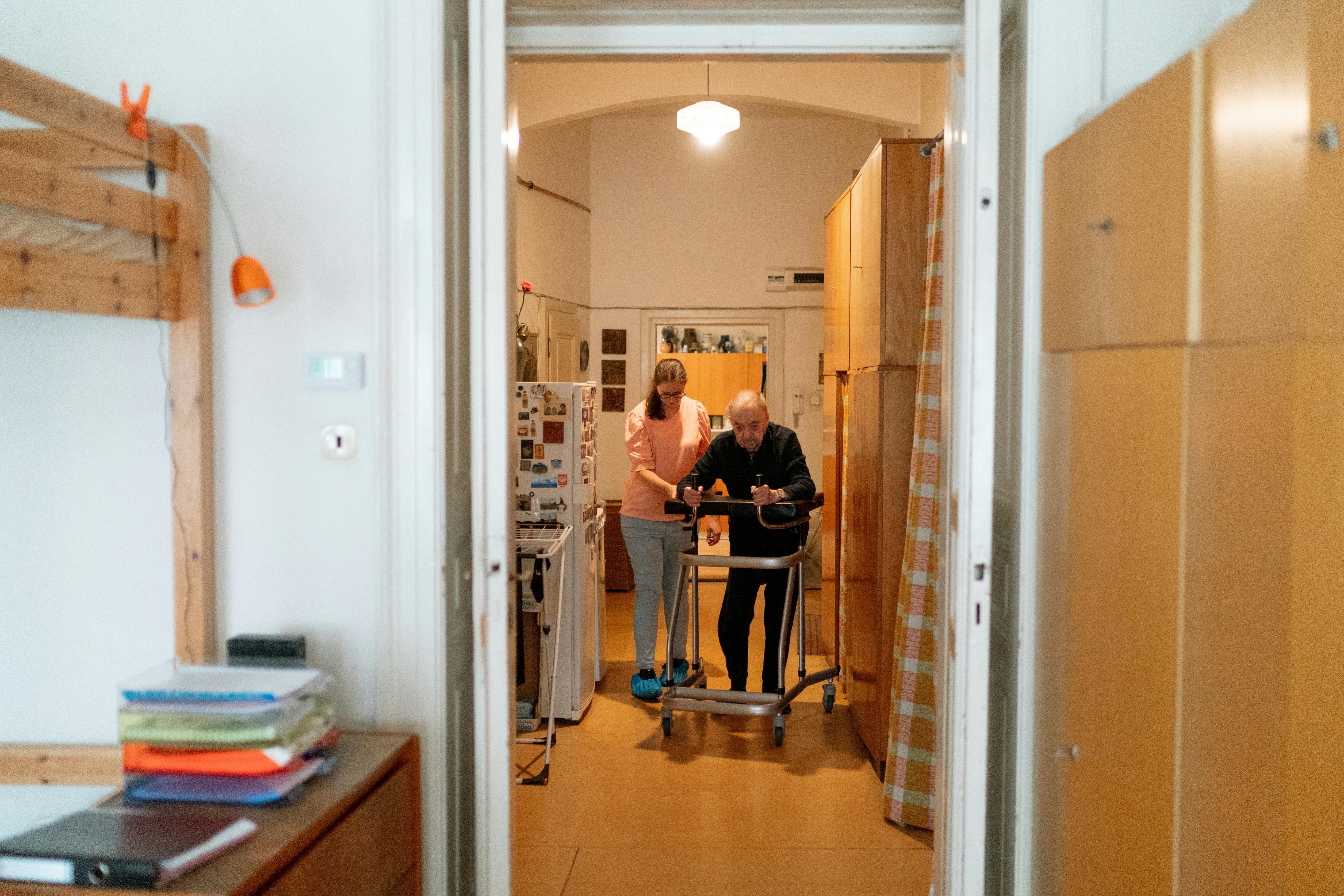 Caregiver assisting an older adult at home